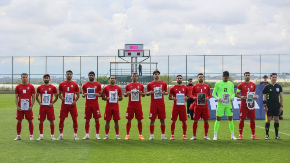 Iran players in Turkey pose with photos of young war victims