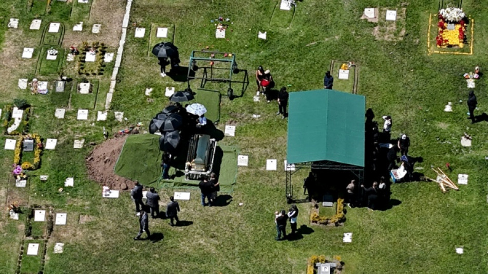 Flowers, music, and soldiers at funeral of drug lord