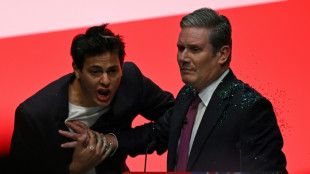 Activist arrested after showering glitter on UK opposition leader