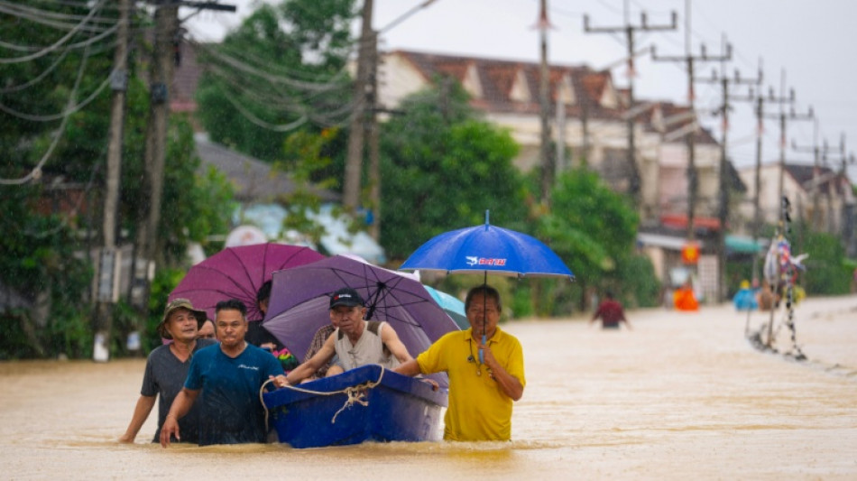 Thailand floods kill 13, leaving people stranded and roads submerged